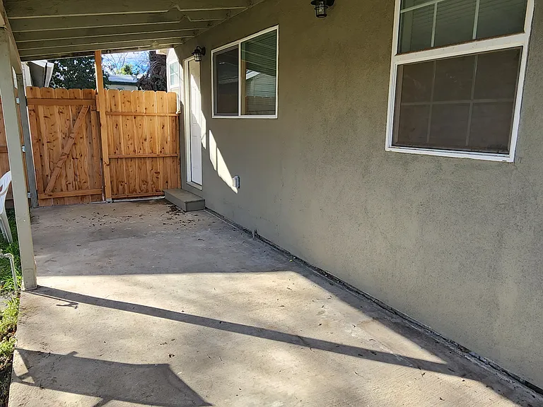 Large covered patio spans the back of the house.