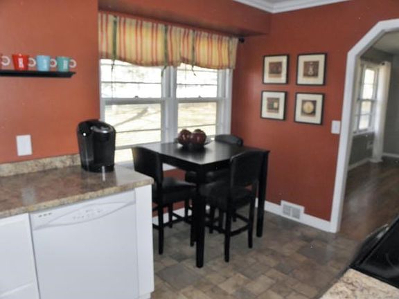 Another view of kitchen showing eating area.