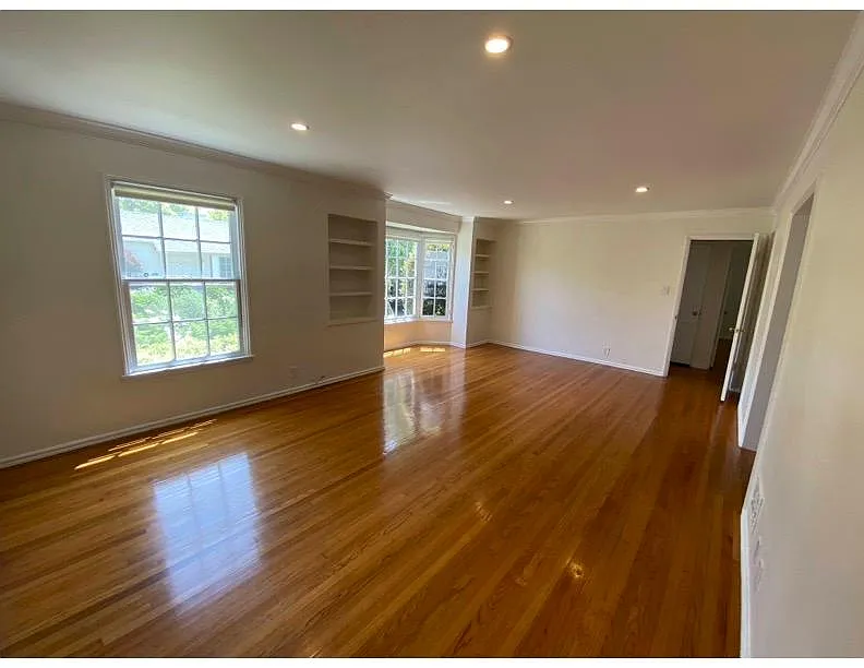 Livingroom with large bay window and built in book shelves. - 960 10th St #2