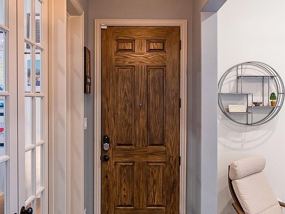 Inside facing the front door. Work or study from home in the private office (left), flex space-formal dining (right), or additional pocket office (next to kitchen).