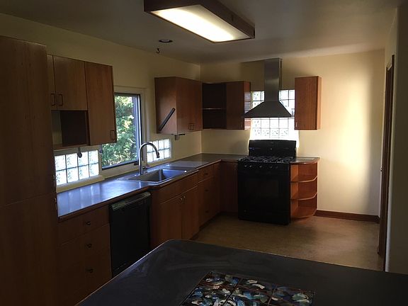 Cook's kitchen with new dishwasher, big sink, and gas stove.