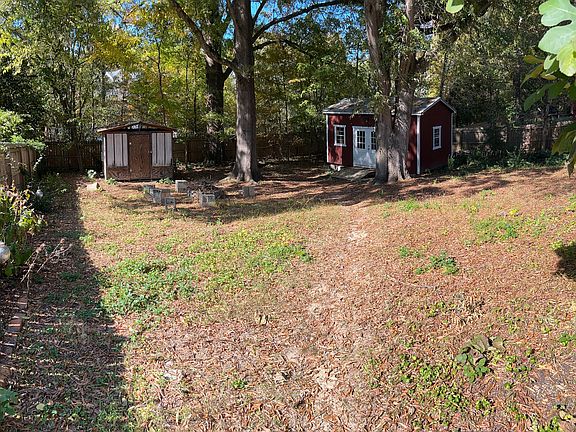 Backyard with garden shed and detached hobby, work, storage space.