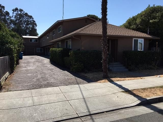 Building front, enter at driveway and up stairs in middle of carport.