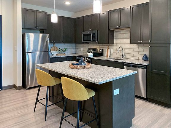 Our kitchens feature spacious layouts and modern stainless steel appliances.