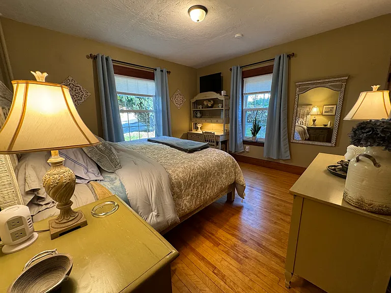 The curtains and mini blinds in this front bedroom were listed as blackout mini blinds and curtains.