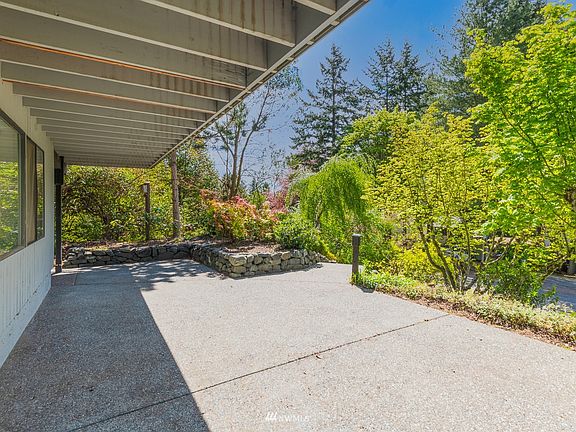 Aggregate rock concrete partially covered patio.