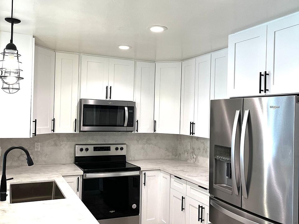 Bright kitchen, all new cabinets, waterfall countertop, sink, appliances, LED lights