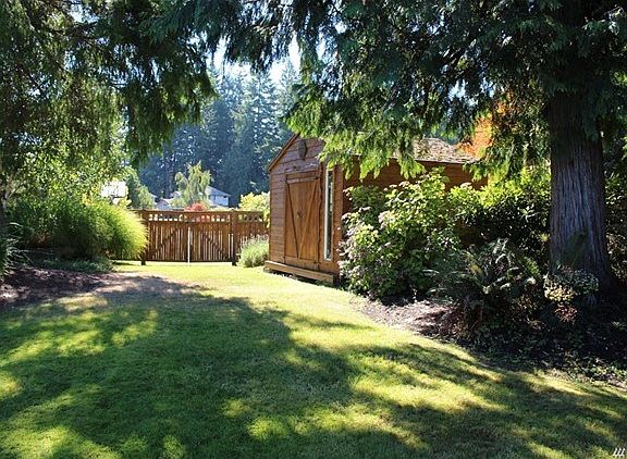 Fenced rear yard with access off the cul-de-sac.  The yard features fruit trees, blue berries and ample garden space.   There are large stepping stones to the fire-pit area and additional stones to sit on for  awhile.