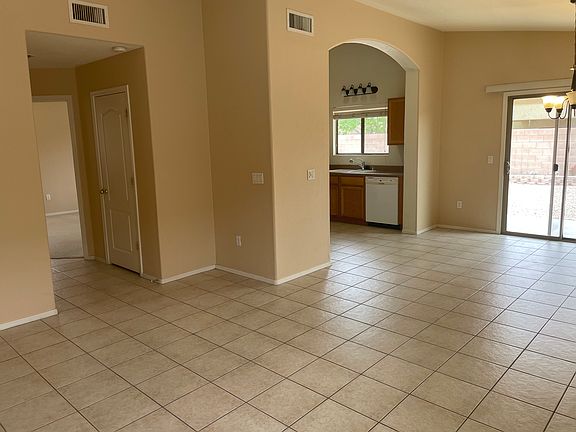 Open floor plan with tiled kitchen, dining and family room