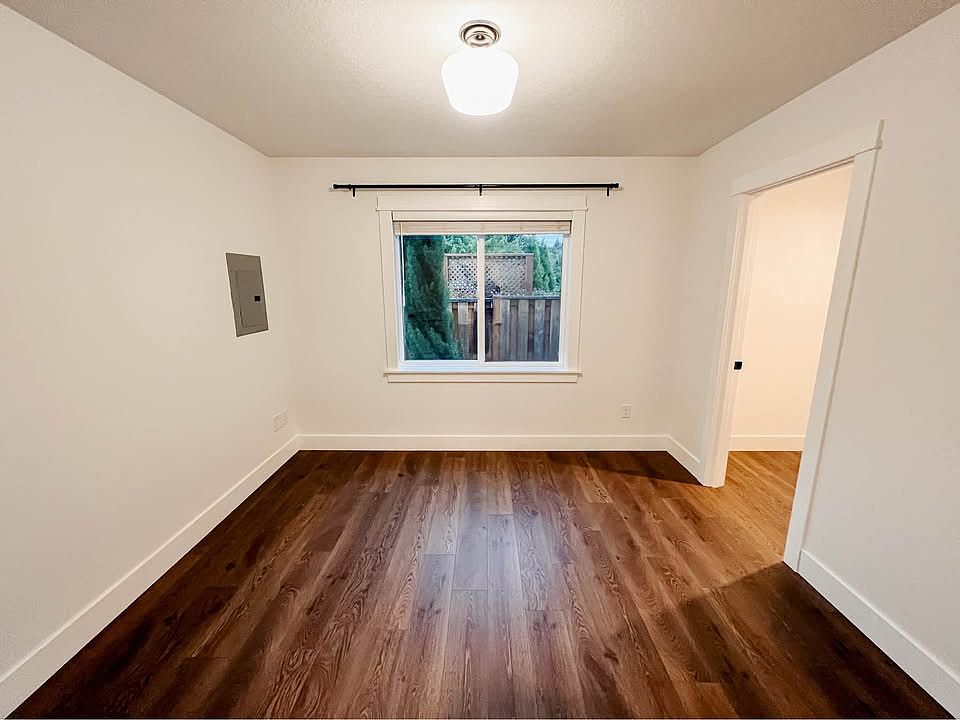 Spacious bedroom comfortably fits a queen bed with room to unwind.