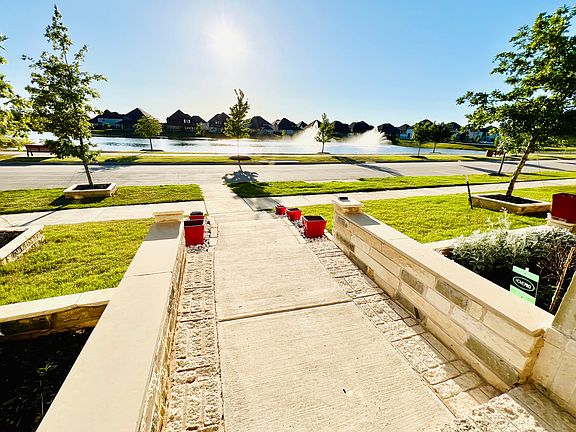 Front patio overlooking a lake with a cascading fountain.