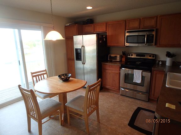 Kitchen includes a dinette and patio door out to the deck.