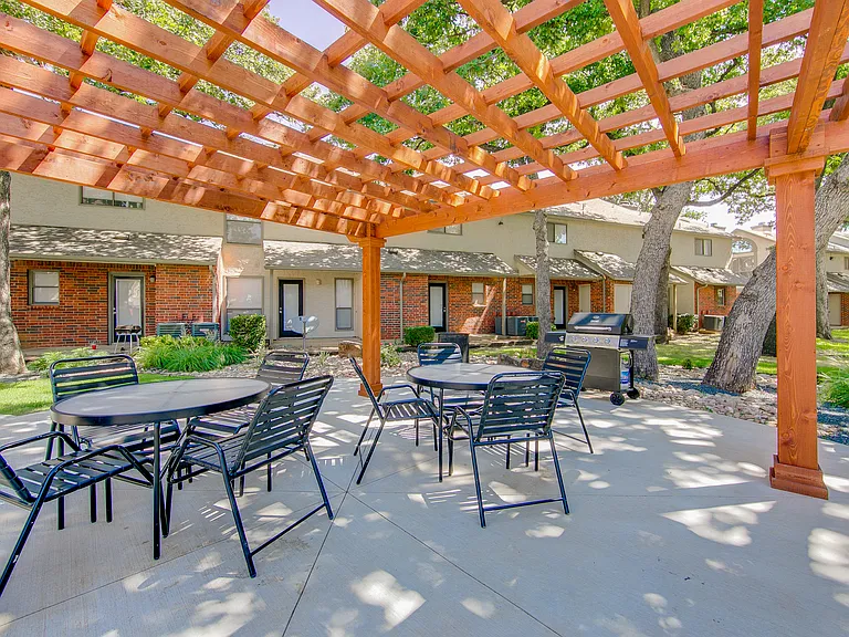 Outdoor pergola with seating area near the pool_great for relaxing or socializing.