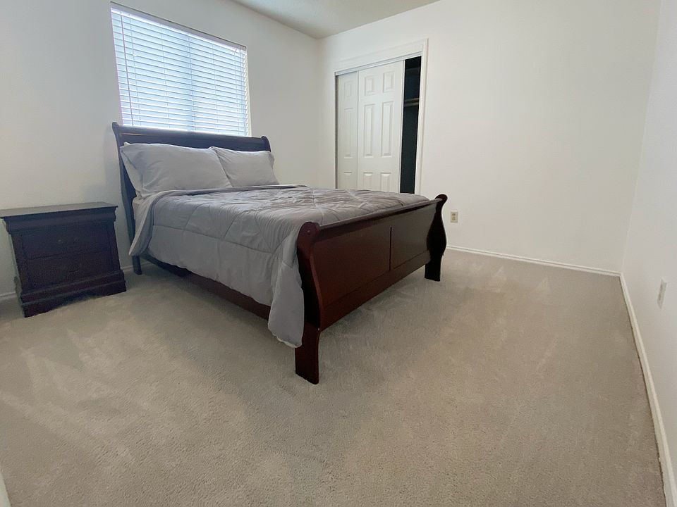 Bedroom has a full sized bed in photo (not included). The room has a ceiling fan and closet with a sliding door.