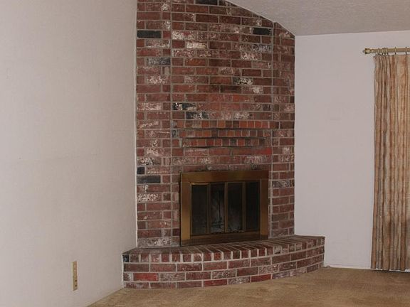 CORNER FIREPLACE IS THE FOCALPOINT OF THE DEN