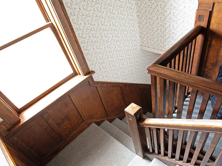 Interior front stairs from unit to first floor front entrance.