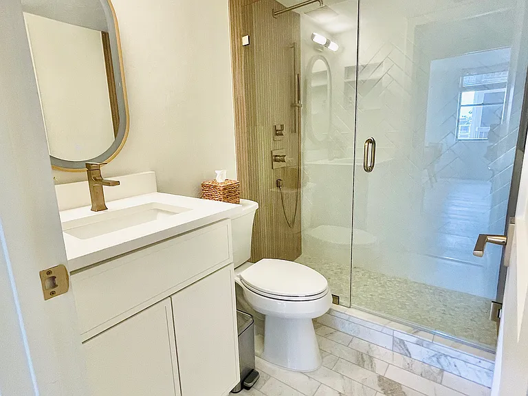 Guest bathroom w/marble tiles and LED mirror