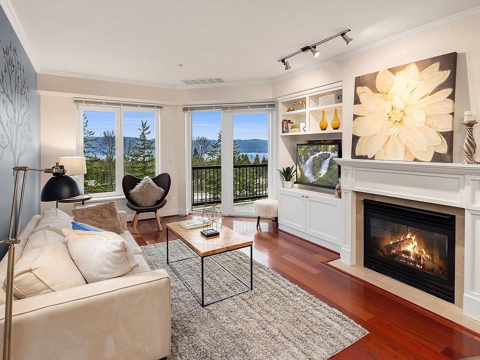 Livingroom and balcony with lake views. Built-in cabinetry for television and shelving. Gas fireplace to warm your evenings. Air conditioning for summer heat.