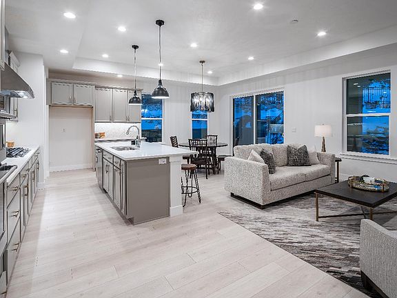 Beautiful great room, kitchen, and dining room with upgraded flooring