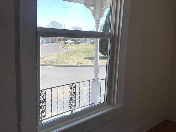 living room front window looking onto porch and park across the street