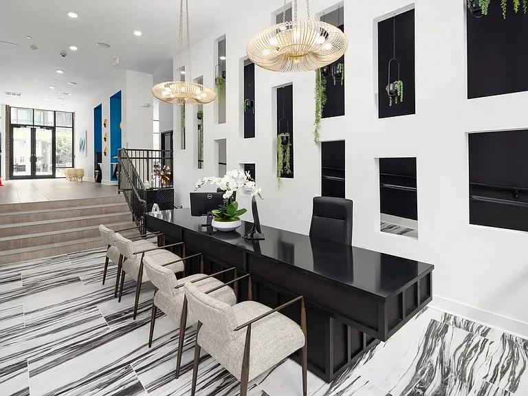 Bright and Bold Reception Space with Monochrome Flooring and Custom Wall Niches