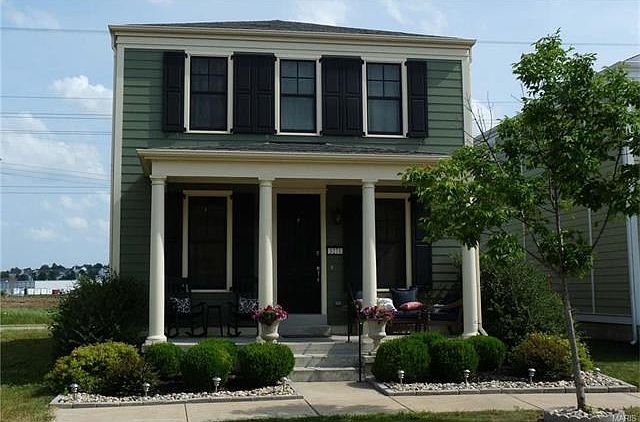 Covered porch, hardwood flooring & 9' ceilings on main level.  This home backs open ground and features two car attached garage.  Walk to all the great things you'll find in New Town!