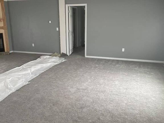 The living room is a GREAT Room with wood burning fireplace.. Will look beautiful when completed.