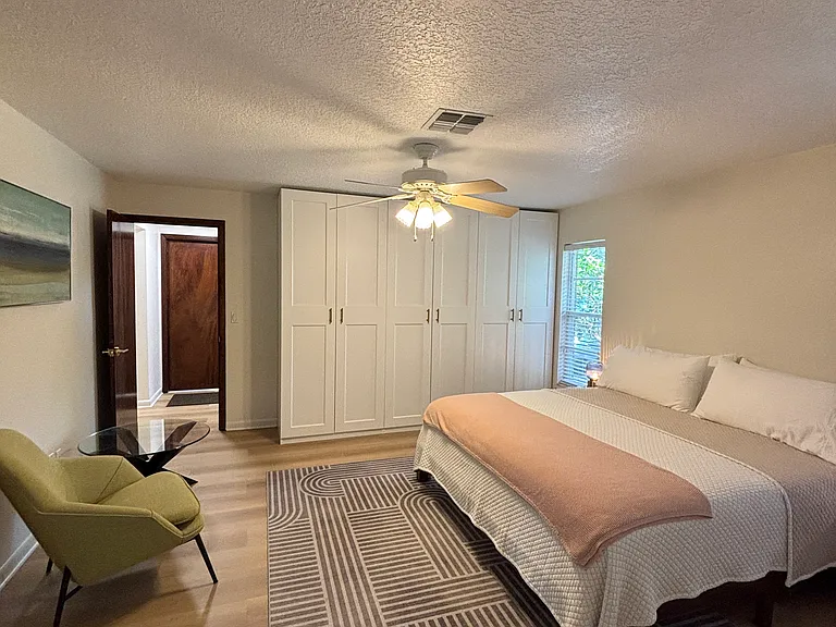 Master bedroom on one end of the house. King bed.