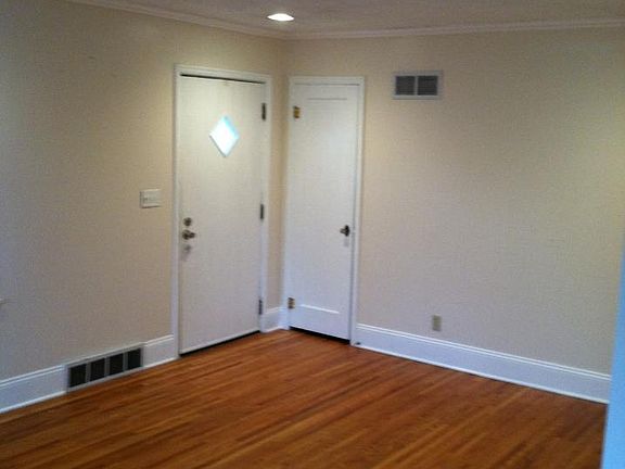 Living room facing front door and coat closet