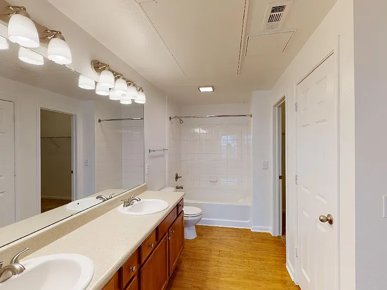 Apartment bathroom with double sinks.