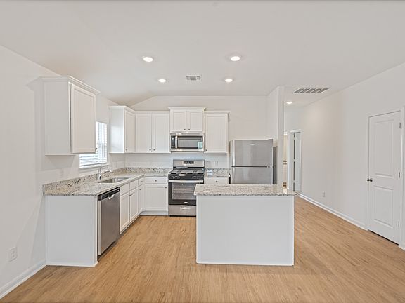 The kitchen comes with white cabinets and granite countertops you will love!