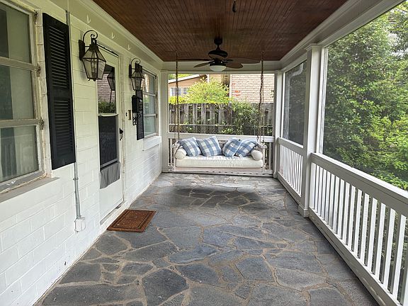 Screened in front porch with swing