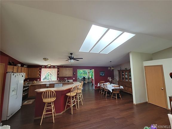 The flooring is engineered hardwood and runs throughout the home. Door to the right is a large coat closet and the entry ahead leads to the new family room addition.