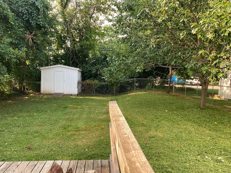Large fenced in back yard , deck, and yard barn