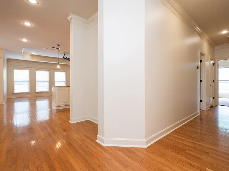From front door looking down hallway to bedrooms and laundry and kitchen/living.