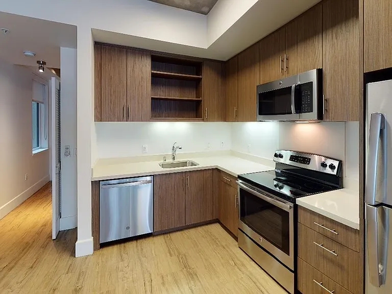 Stylish kitchen with stainless steel appliances and quartz countertops