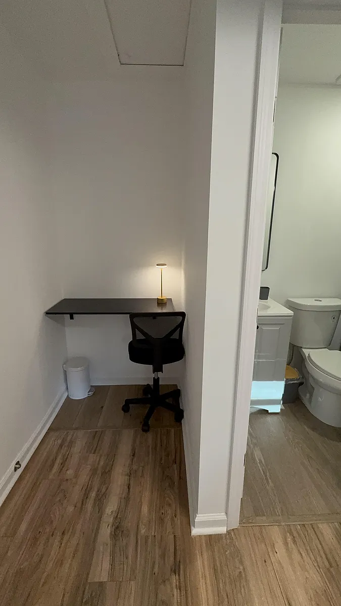 Dedicated work nook with a wall-mounted desk and task lighting, set just outside a nearby bathroom for convenience. - Trickum Hills Way