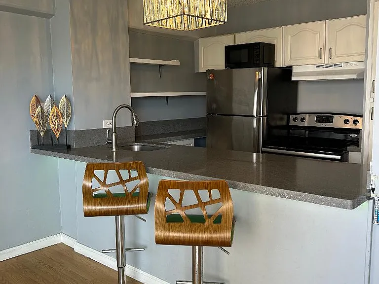 Complete kitchen with Stainless Steel Refrigerator and Stove/Oven. Granite Counter top