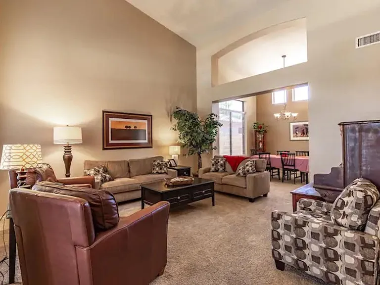 High ceilings and lots of great seating fill this cozy front sitting room.