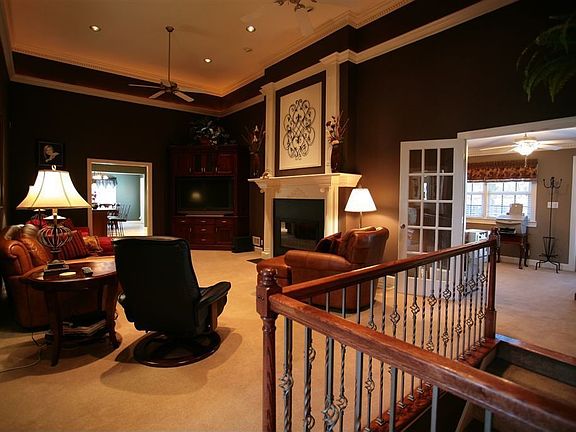 Check out the two levels of crown, recessed lighting, and an oversized firepla