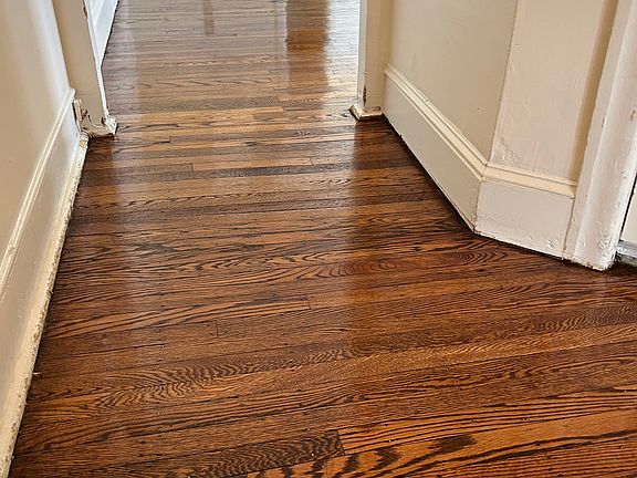 Newly renovated hardwood floors with storage closet in hallway