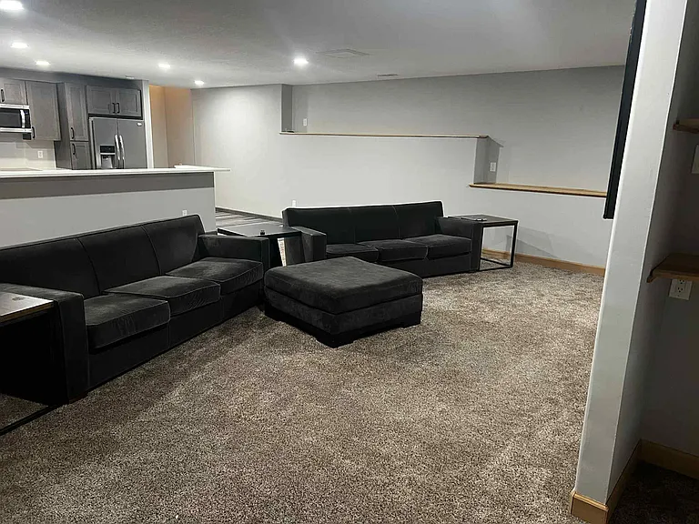 Living room. Kitchen in background.