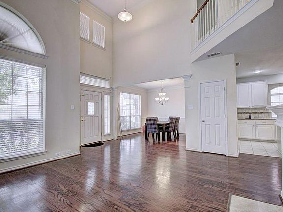 High Ceiling Living Room with great light and beautiful hardwood floor