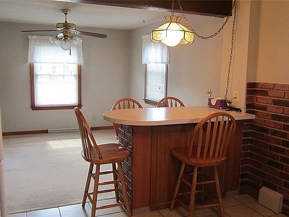 The Kitchen has been opened to the Dining Room and is separated by a wide, double-sided Snack Bar with storage underneath and all four bar stools stay!