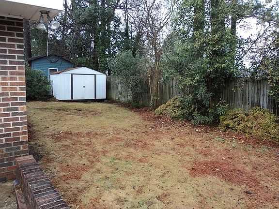 fenced yard with storage she