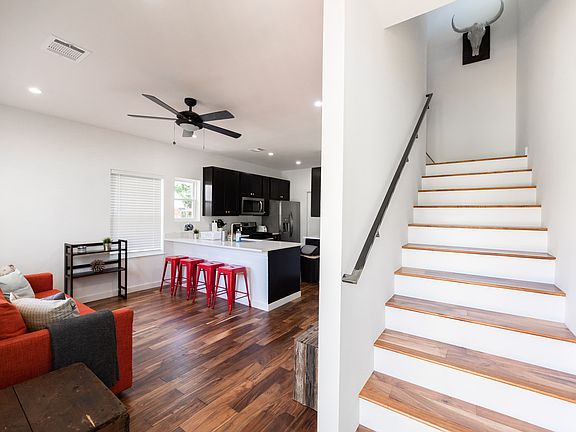 Stairs to the second floor next to living room