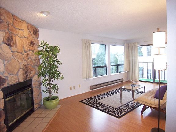 Spacious living room is light and bright in this southernmost top floor unit. Curl up to a cozy fire, or on a nice day, throw open your slider and enjoy your morning coffee or afternoon cocktail on your deck.