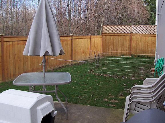 Glimpse at side yard, dog run fencing removable.
