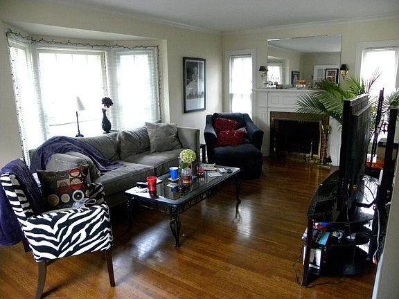 Living Room with fireplace and hardwood floors and bay window