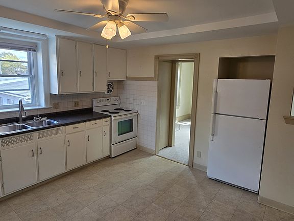 Eat-in kitchen with doorway leading into living room.